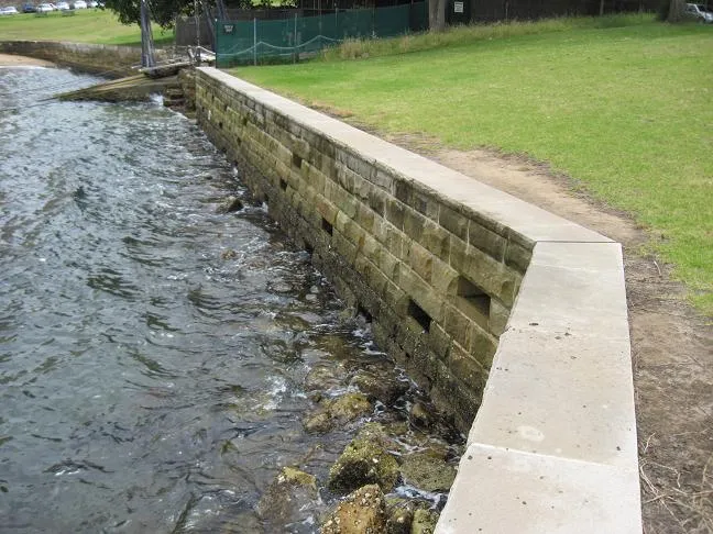 Concrete seawall with a poured cap along a residential waterway