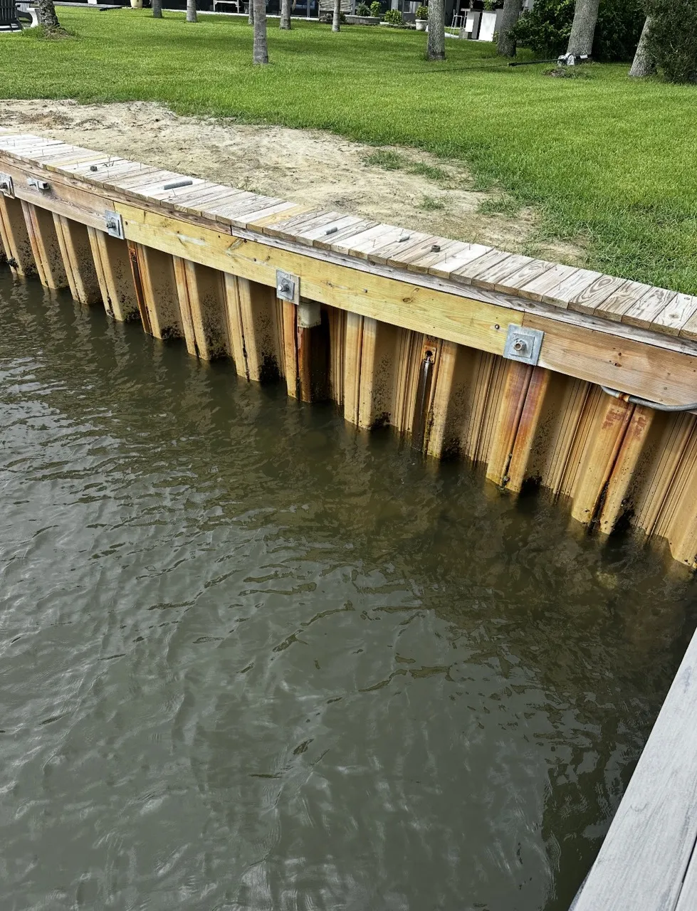 Face of a newly installed bulkhead along a canal